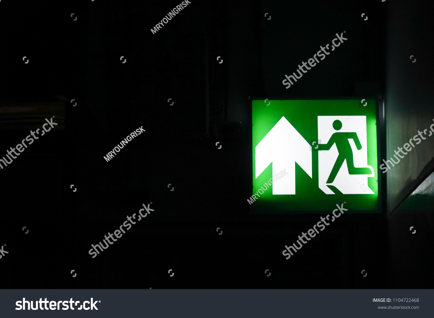 Green Emergency Light Exit Signs Corridors Stock Photo 1104722468