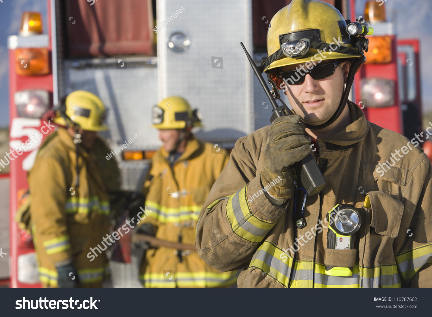 Portrait Firefighter Talking On Radio Colleagues Stock Photo 110787662 ...