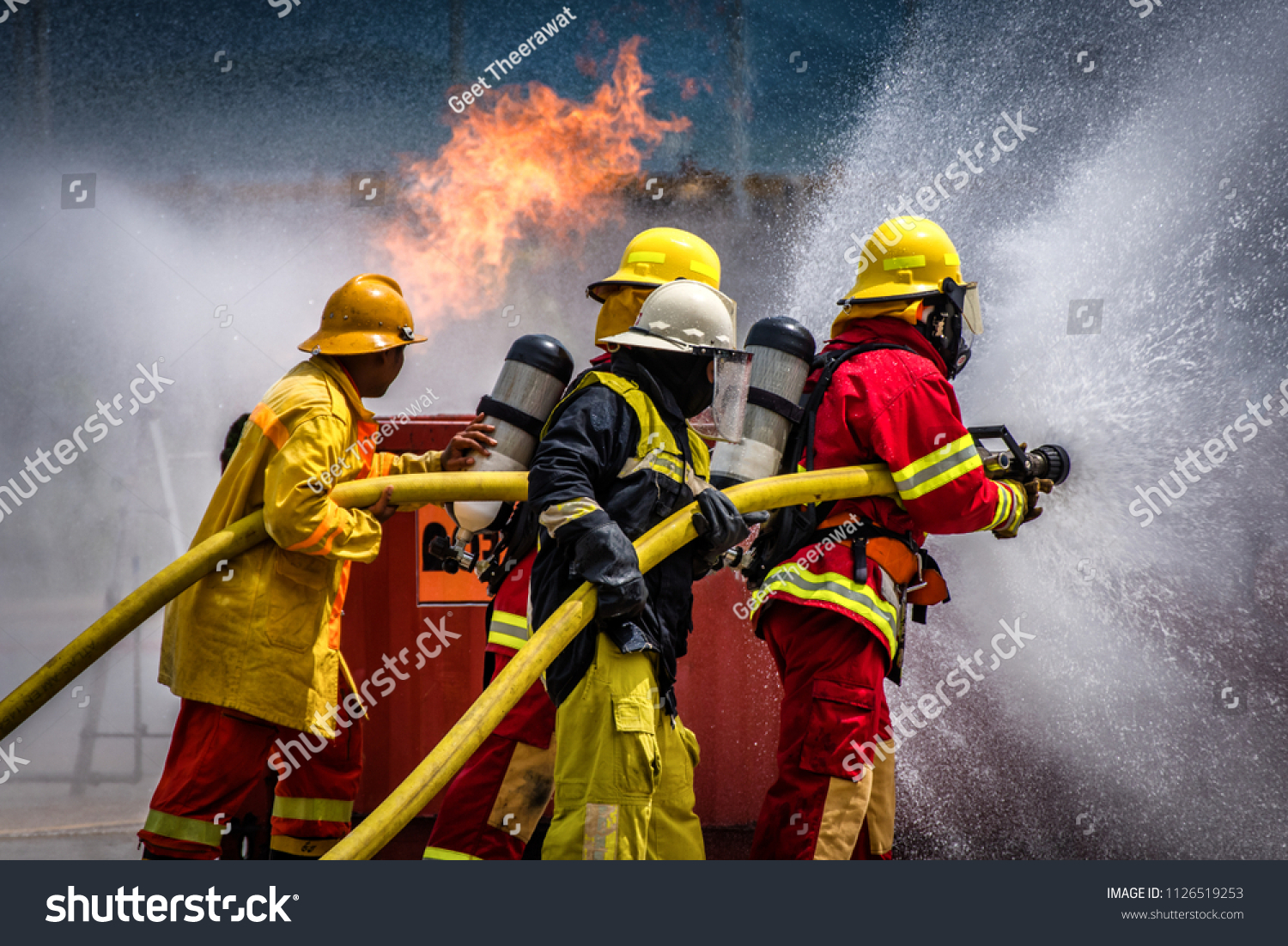 Fireman Using Water Extinguisher Fighting Fire Stock Photo 1126519253 