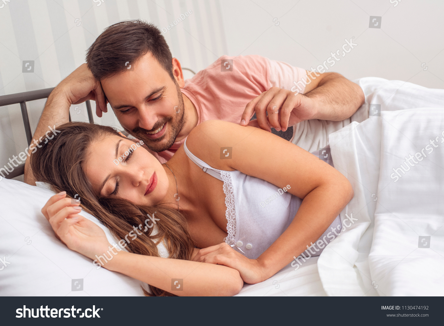 Husband Kissing His Wife Neck Bed Stock picture