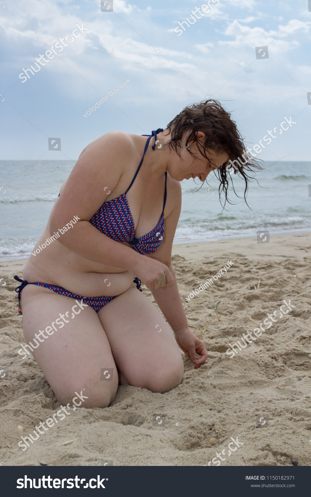 Woman Sitting On Knees On Beacha Stock