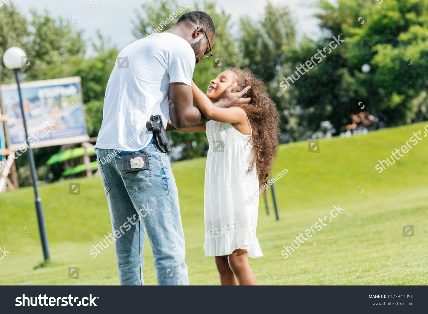 African American Police Officer Hugging Adorable Stock Photo 1173841096