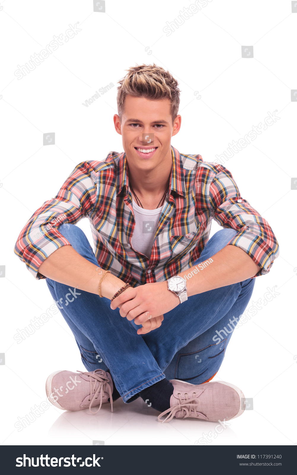 Casual Young Man Sitting Legs Crossed Stock Photo 117391240 Shutterstock   Stock Photo Casual Young Man Sitting With Legs Crossed In Lotus Position And Smiling To The Camera 117391240 