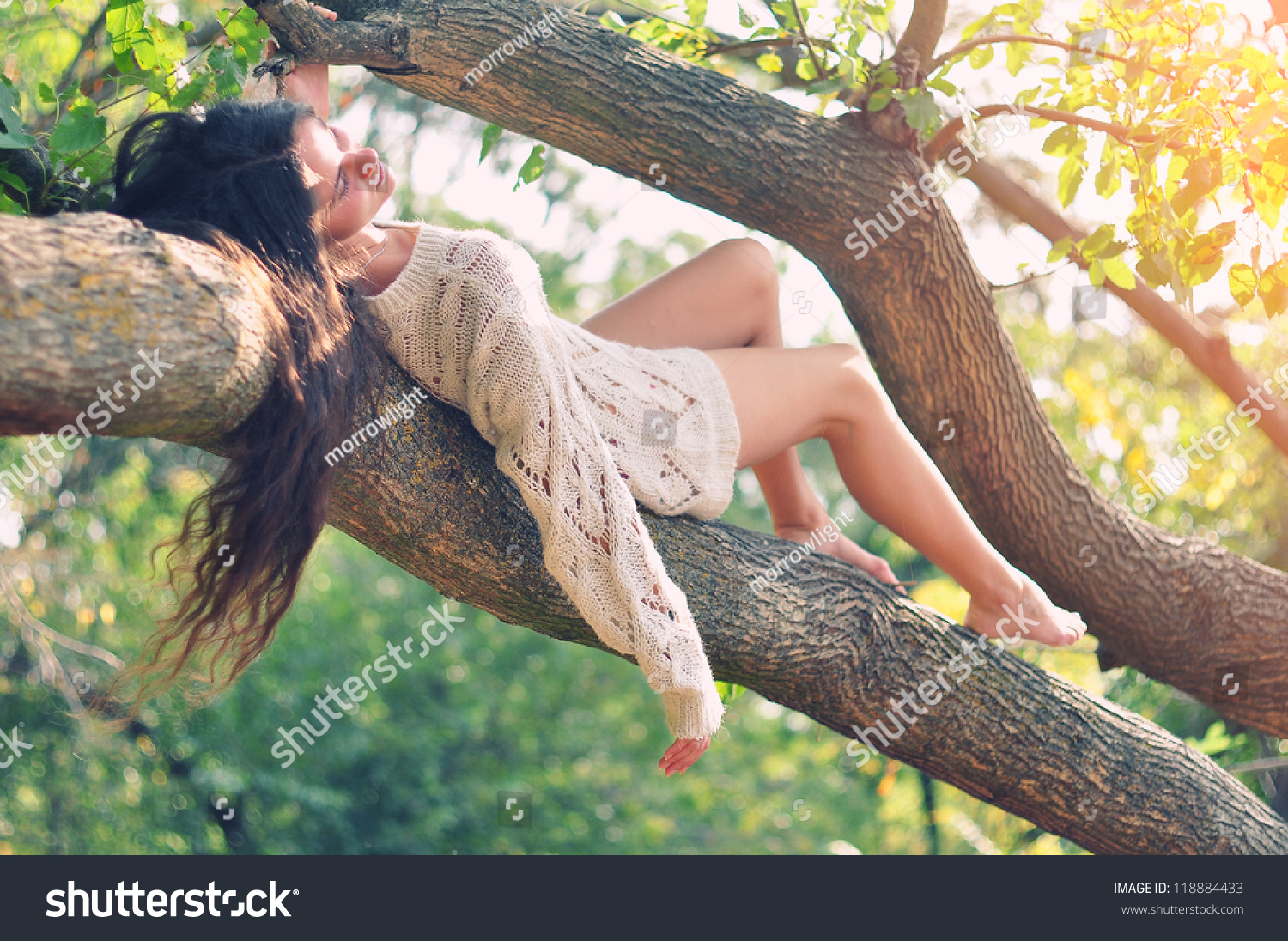 https://image.shutterstock.com/shutterstock/photos/118884433/display_1500/stock-photo-young-caucasian-girl-lying-on-the-branch-of-the-tree-outdoors-at-green-nature-background-118884433.jpg