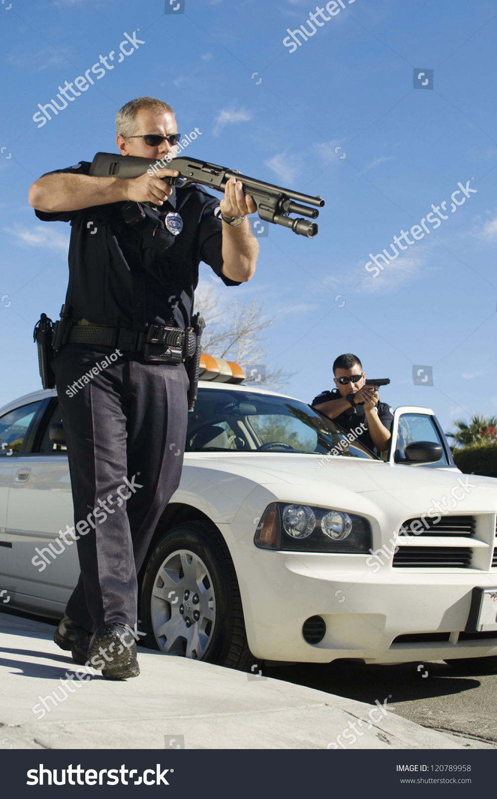 Police Officer Aiming Gun By Car Stock Photo 120789958 | Shutterstock