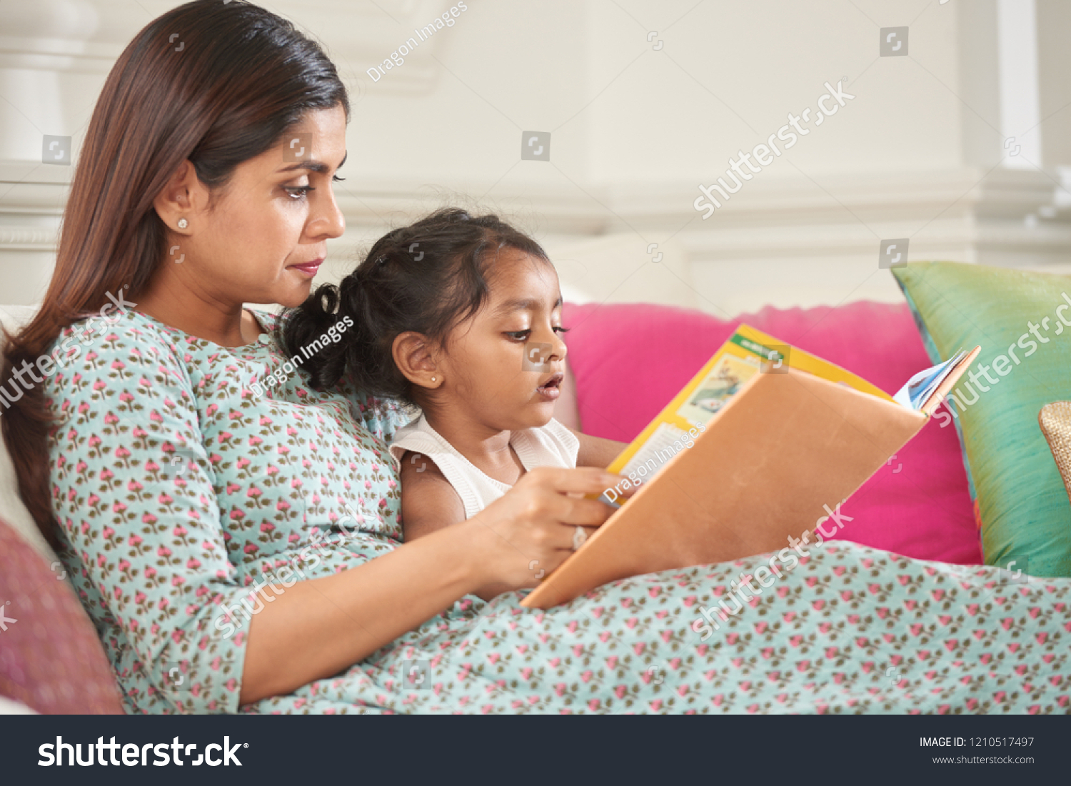 Indian Mother Daughter Reading Fairytale Together Stock Photo ...