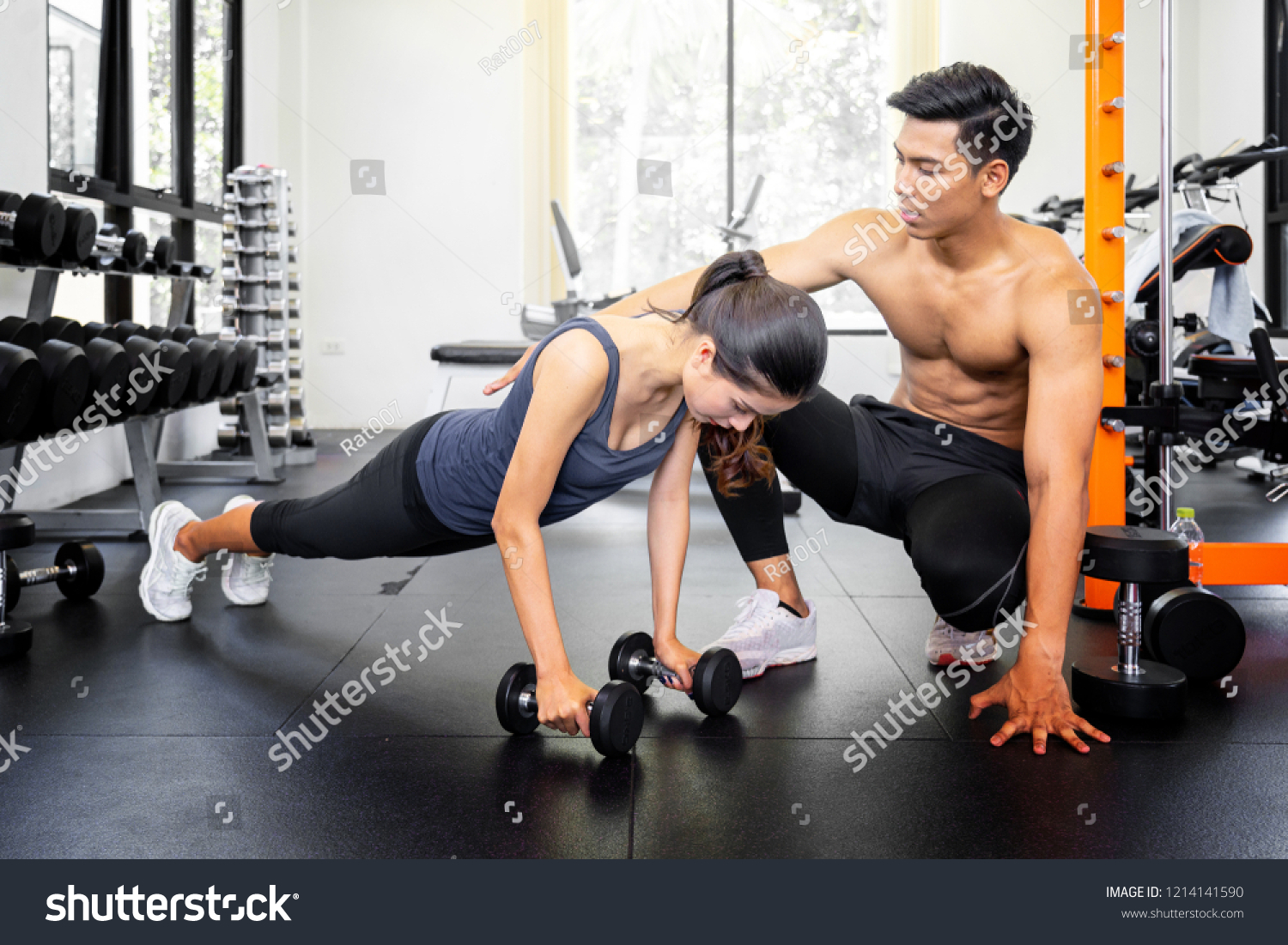 Personal Trainer Coaching Female Bodybuilder Lifting Stock Photo