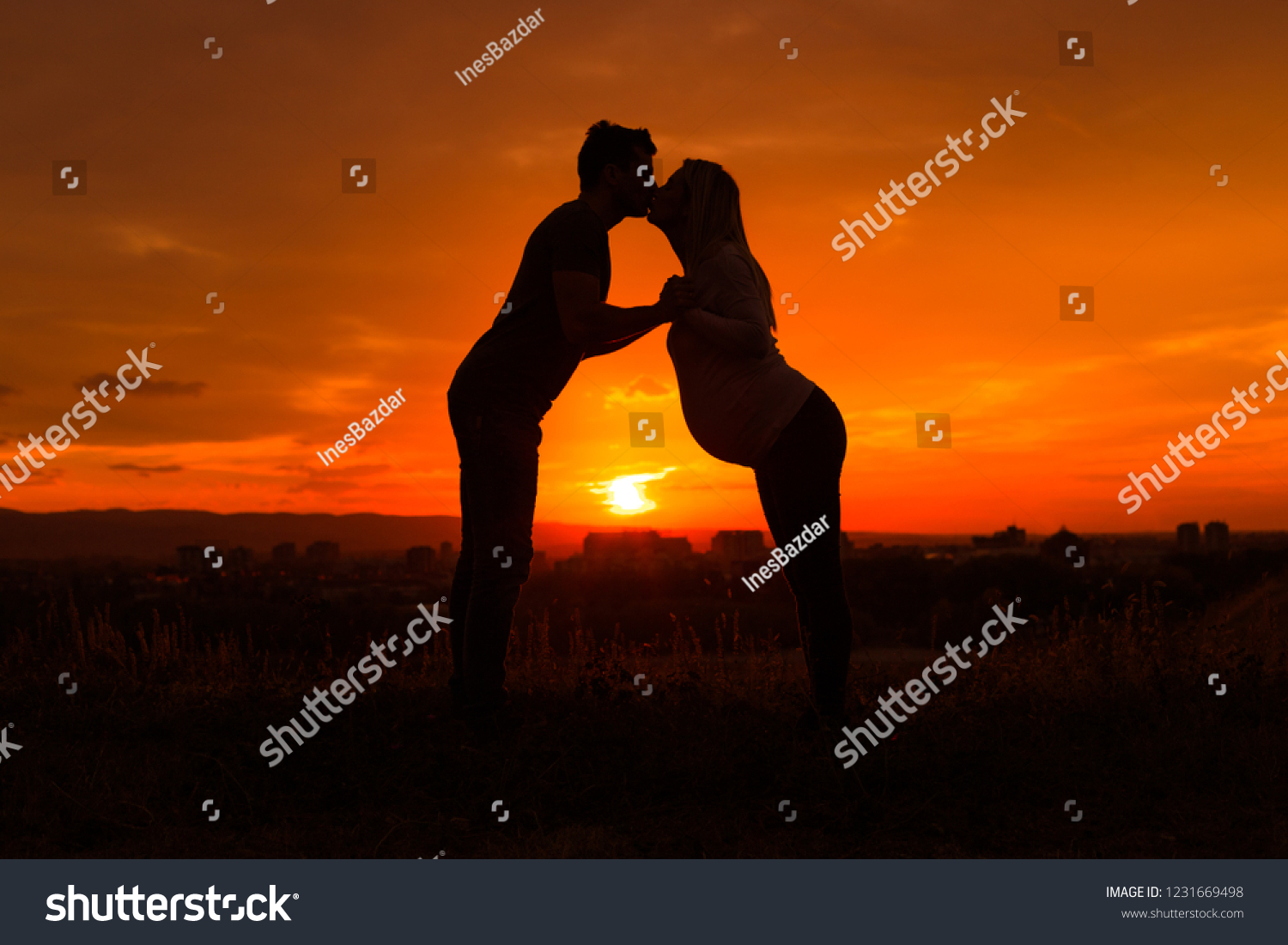 Стоковая фотография 1231669498 Silhouettes Husband Pregnant Wife Kissing While Shutterstock