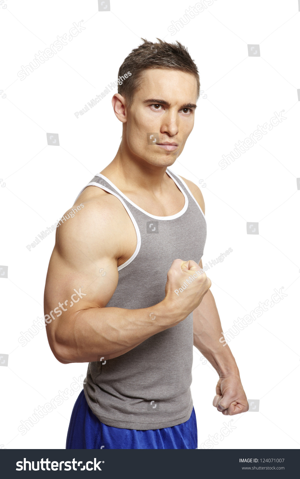 Muscular Young Man Flexing Arm Muscles Stock Photo 124071007 | Shutterstock