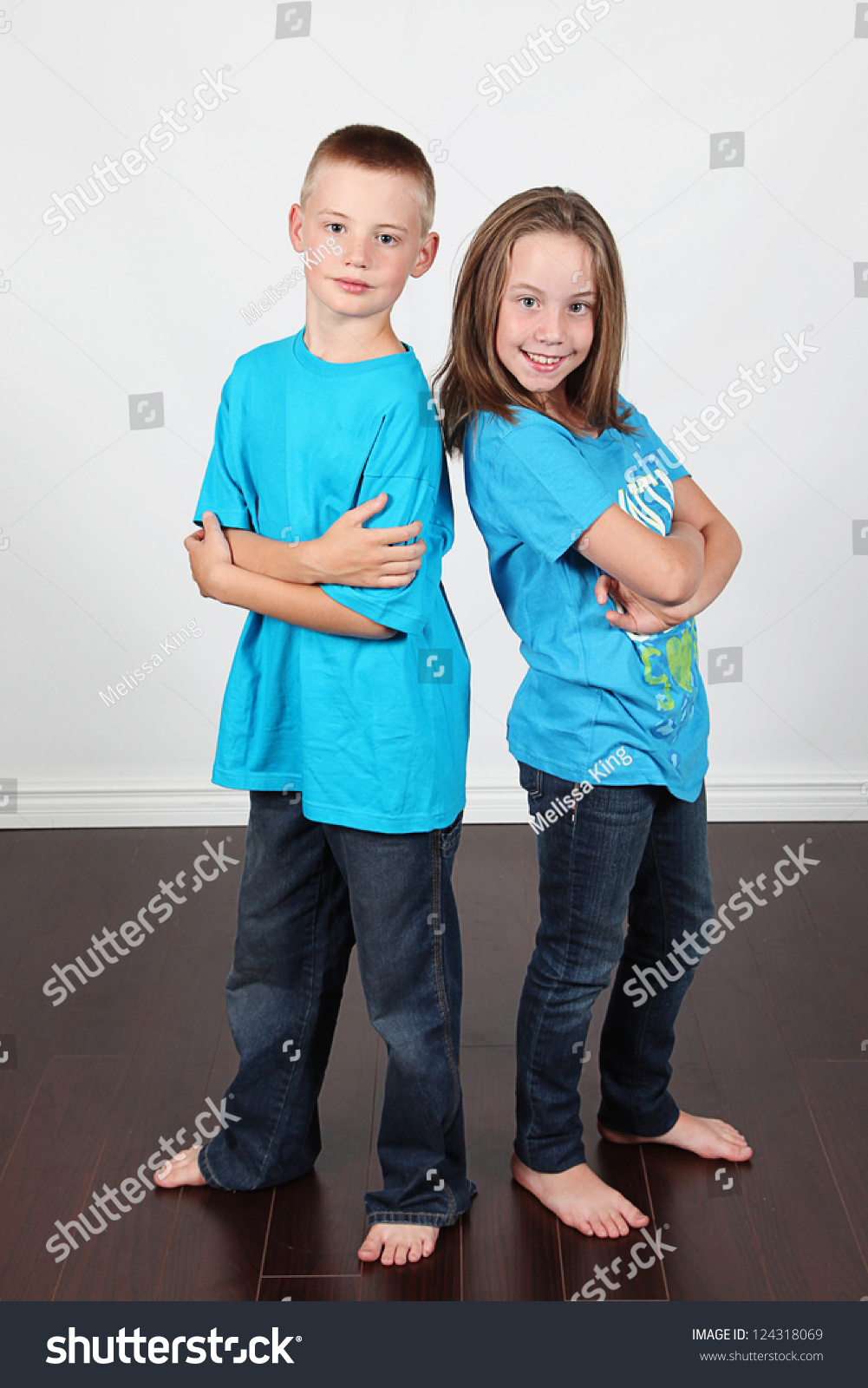 twin-brother-sister-posing-together-studio-stock-photo-124318069