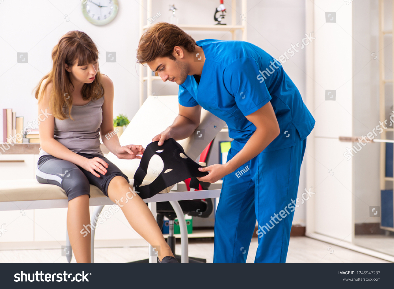 11 073 Physical Therapy Aide Images Stock Photos Vectors Shutterstock   Stock Photo Young Female Patient Visiting Male Doctor Traumatologist 1245947233 