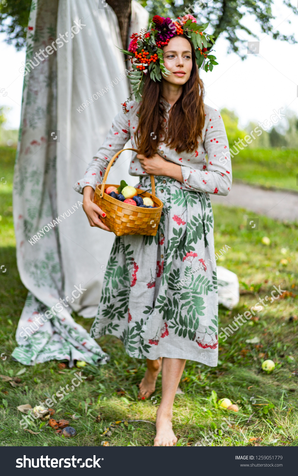 https://image.shutterstock.com/shutterstock/photos/1259051779/display_1500/stock-photo-young-woman-with-a-basket-of-fruits-plums-and-apples-1259051779.jpg