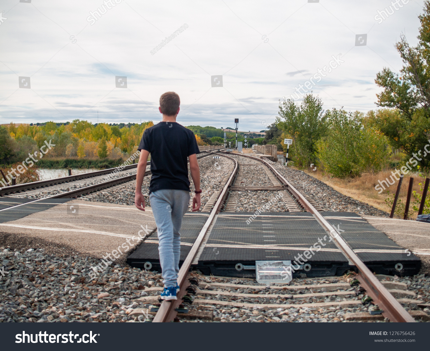 Teenage Boy Walking On Train Tracks Stock Photo 1276756426 | Shutterstock