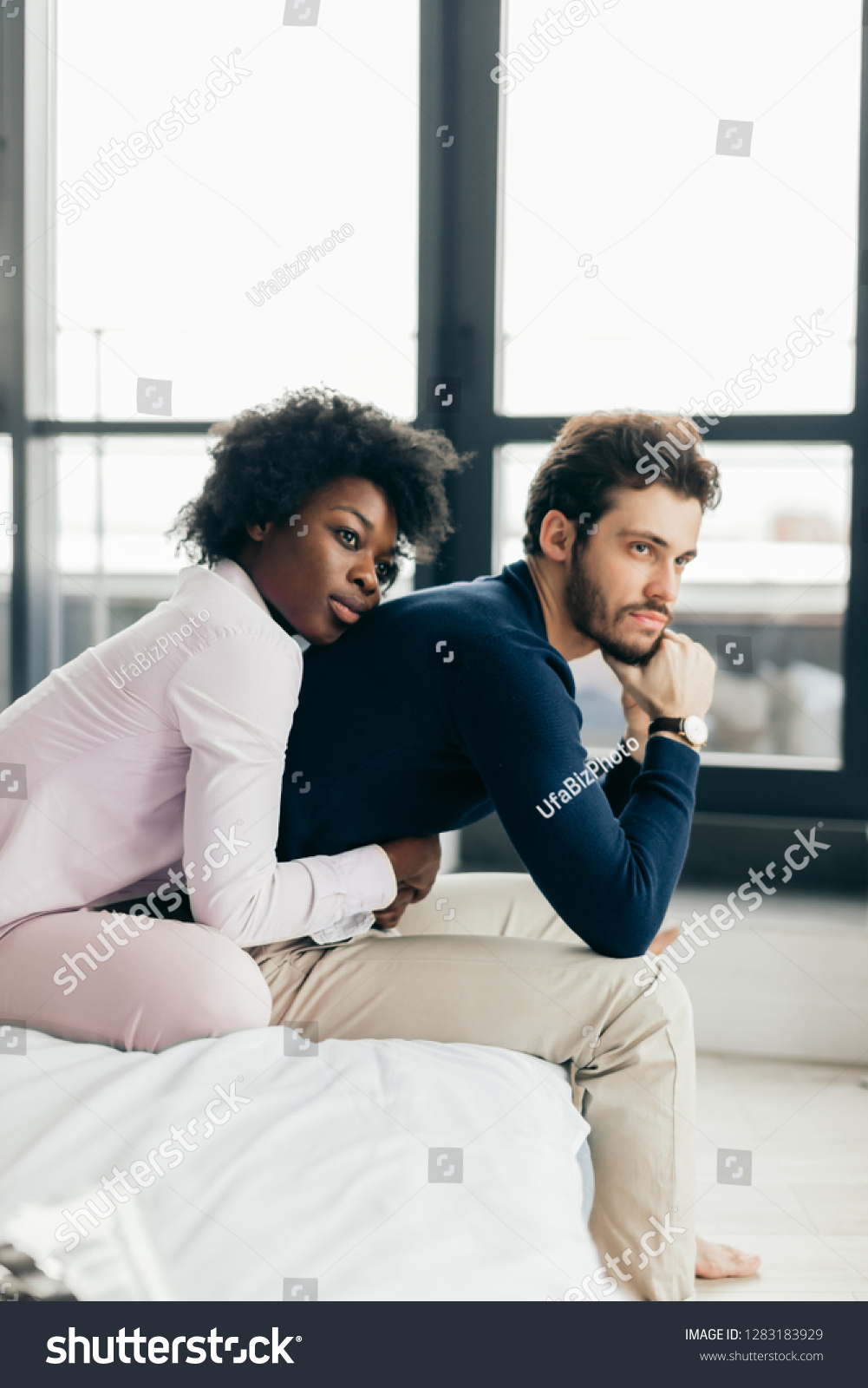 Interracial Couple Bed Stressed photo