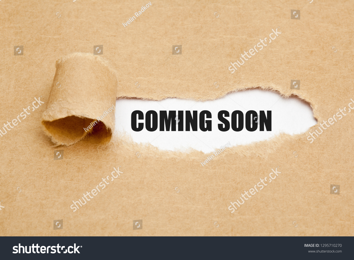 phrase-coming-soon-appearing-behind-ripped-stock-photo-1295710270