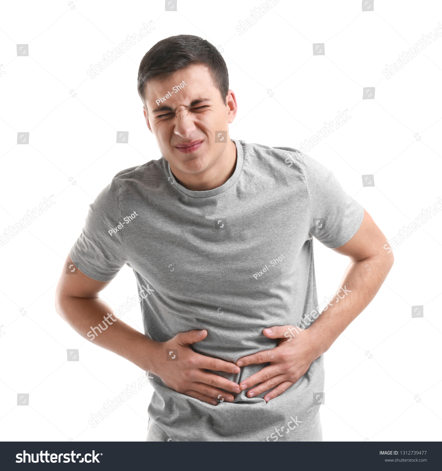 Young Man Suffering Abdominal Pain On Stock Photo 1312739477 | Shutterstock