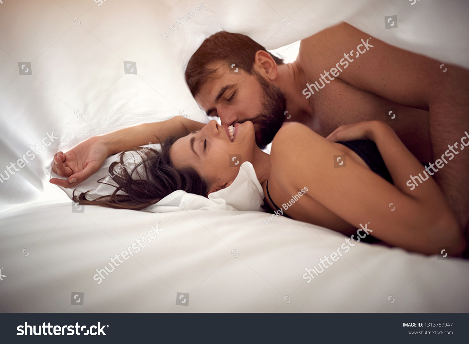 Man And Woman Making Love In Bed