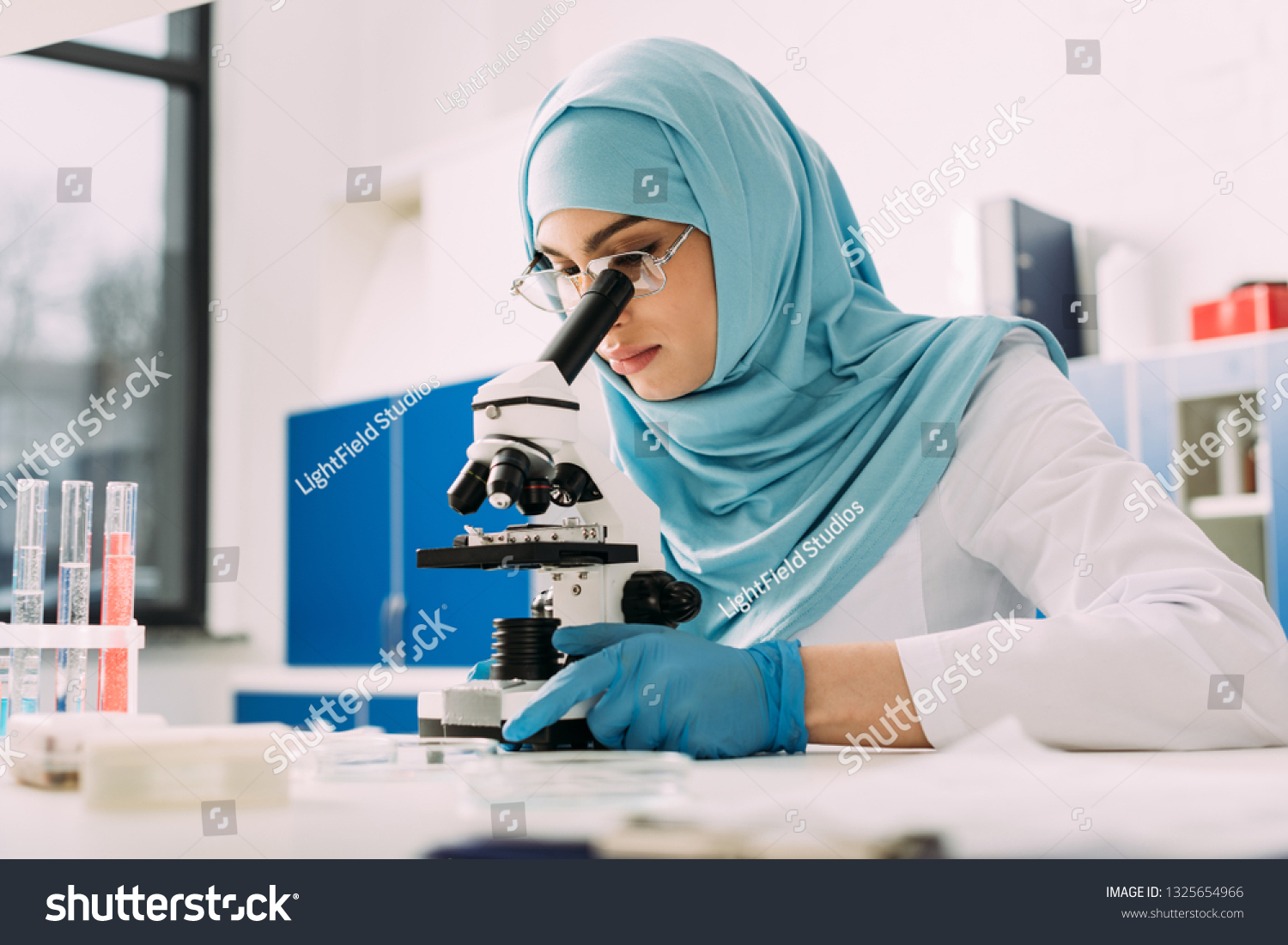 Concentrated Female Muslim Scientist Looking Through Stock Photo ...