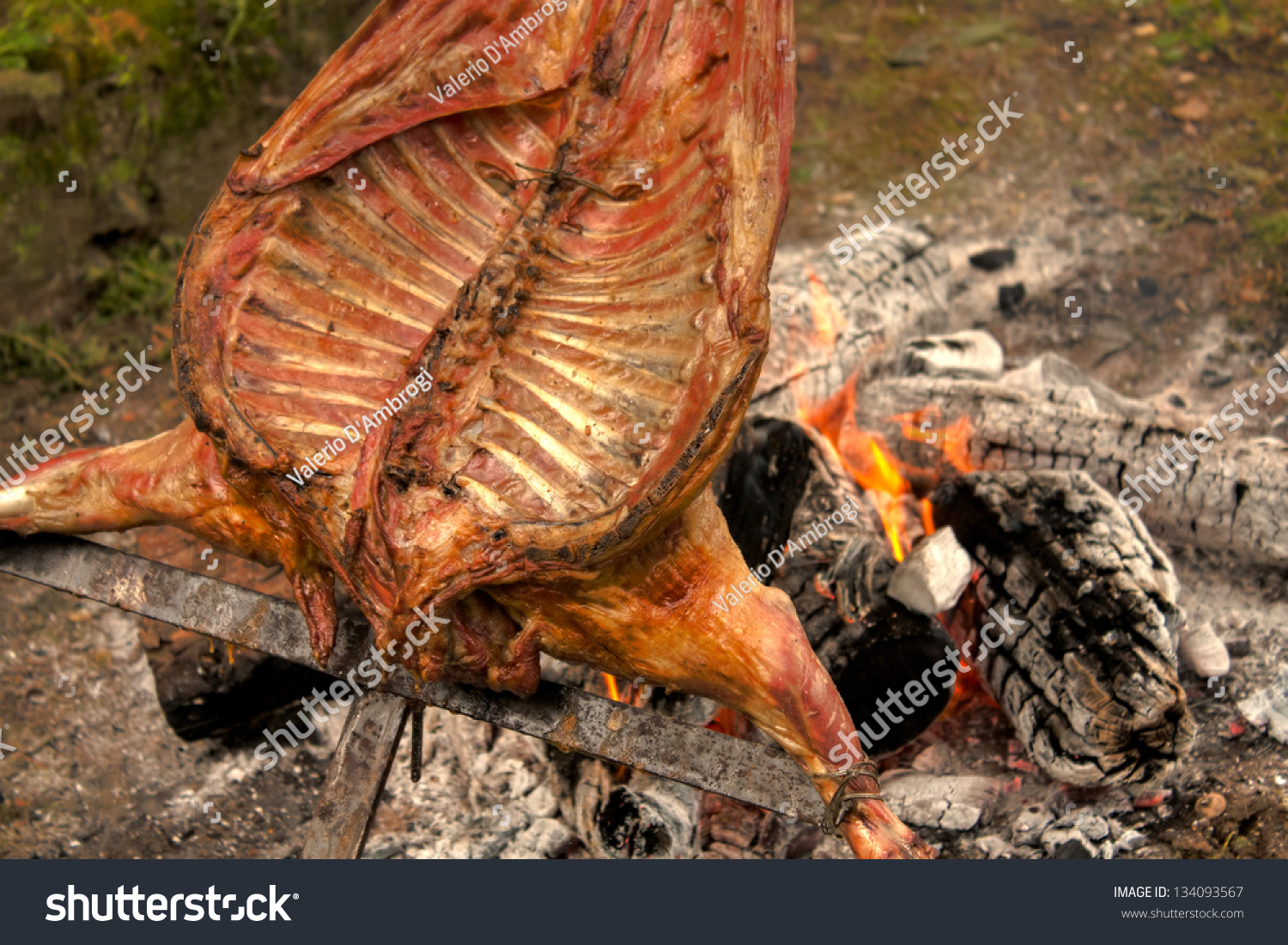 Woman Spit Roasted Over Fire
