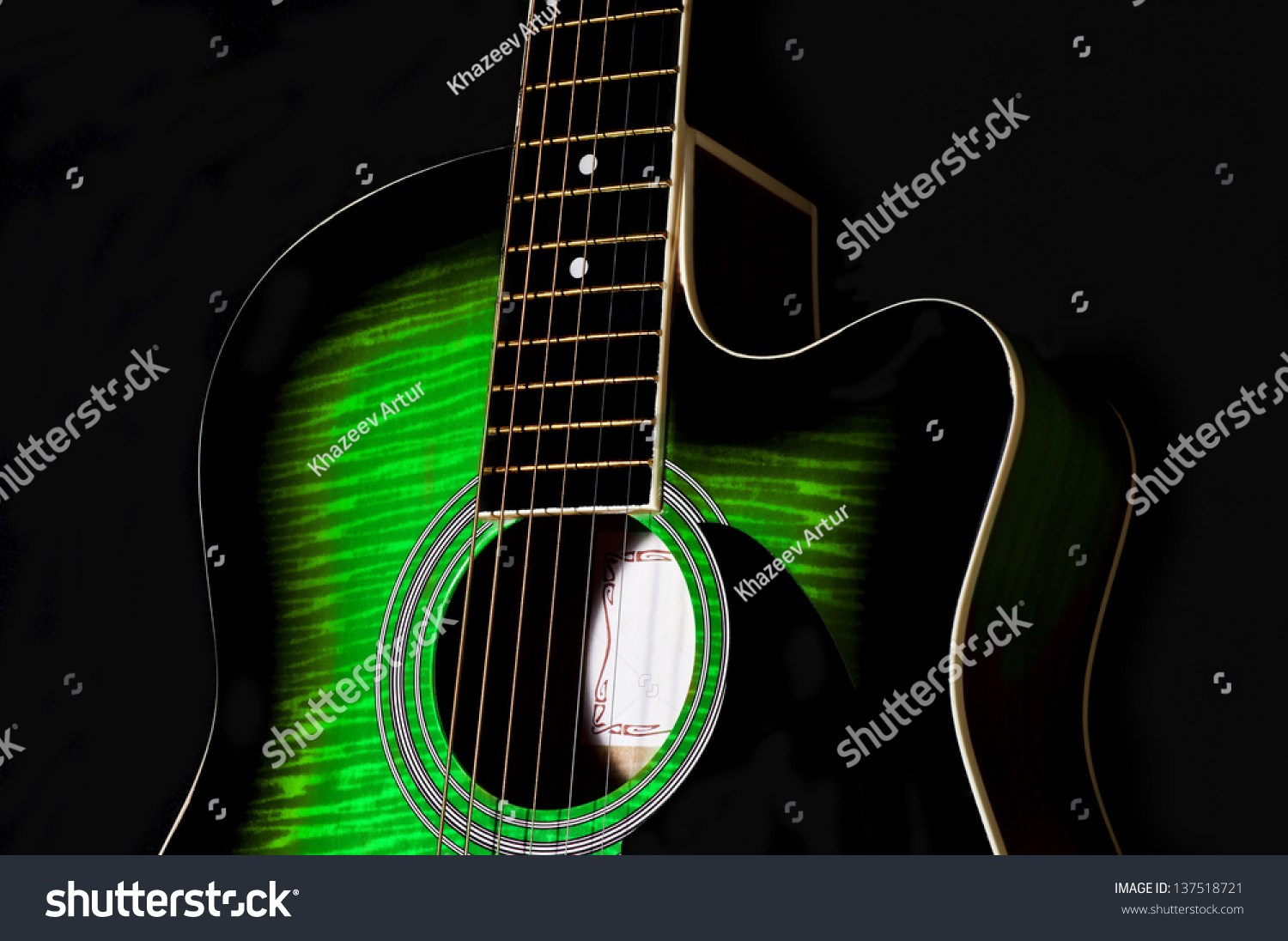 green and black acoustic guitar