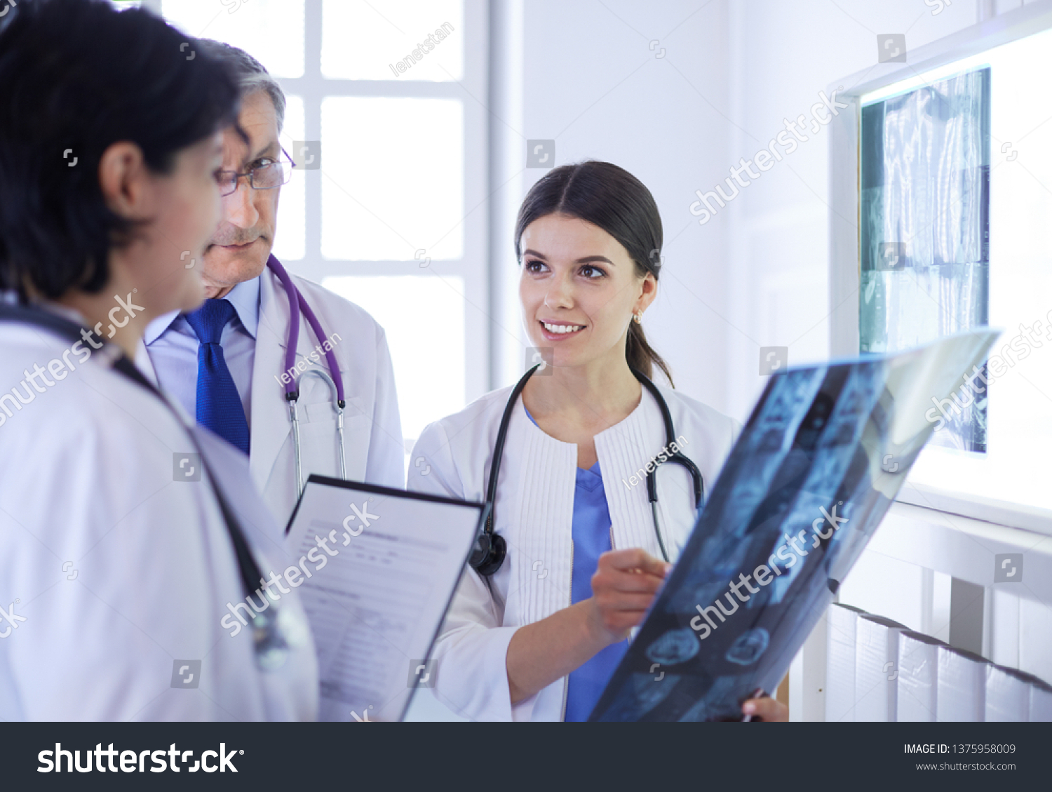 Smiling Doctors Discussing Patients Diagnosis Looking Stock Photo ...