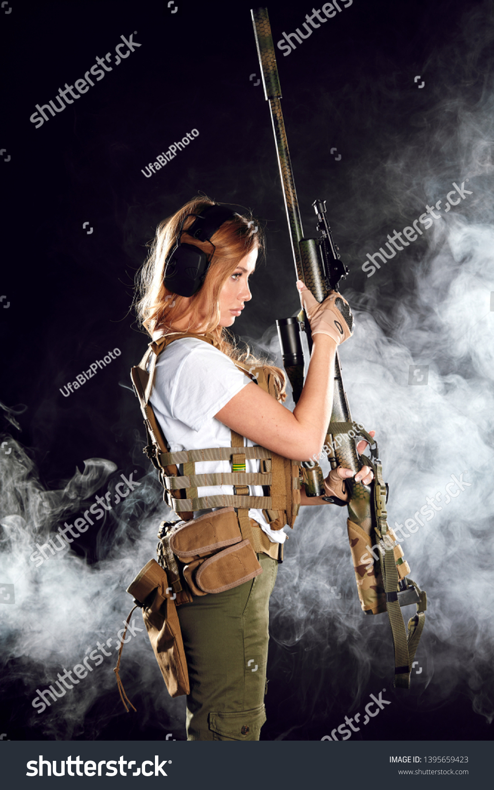 Skilled Blonde Female Soldier With Rifle In Hands Standing In Military