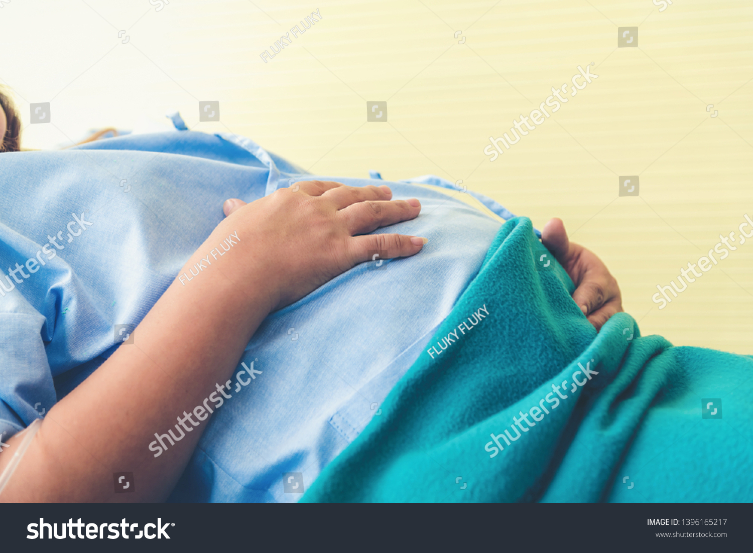 pregnant-woman-lying-on-bed-waiting-stock-photo-1396165217-shutterstock