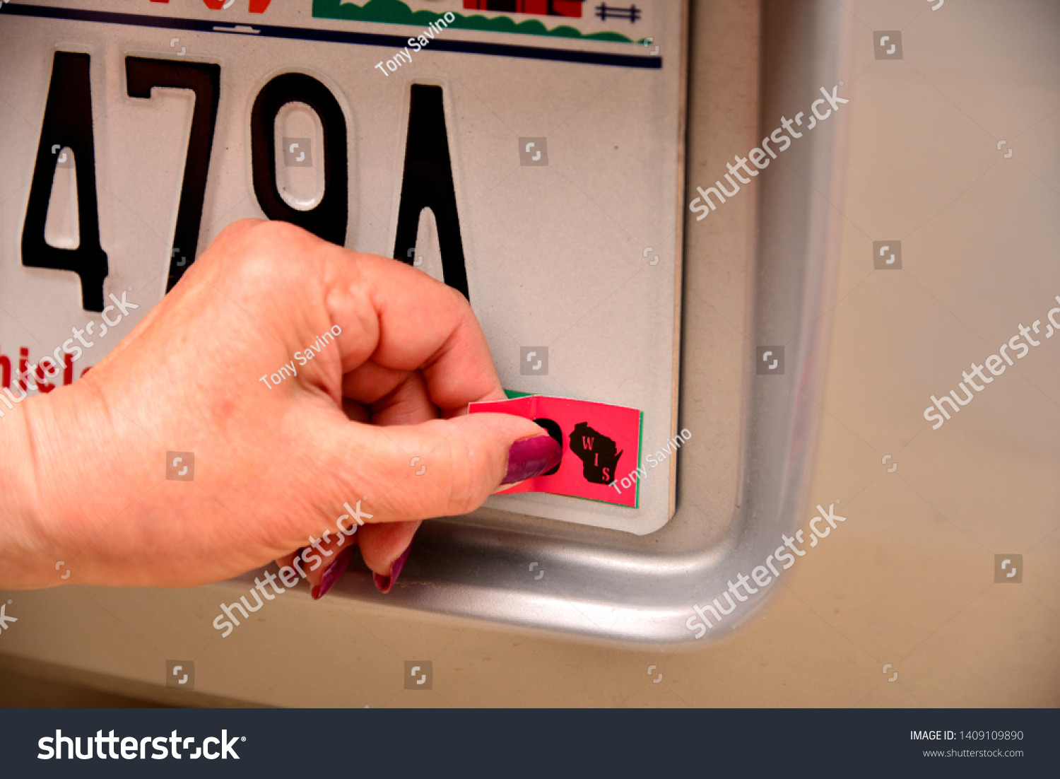 Left Female Hand Applying Registration Sticker Stock Photo 1409109890 