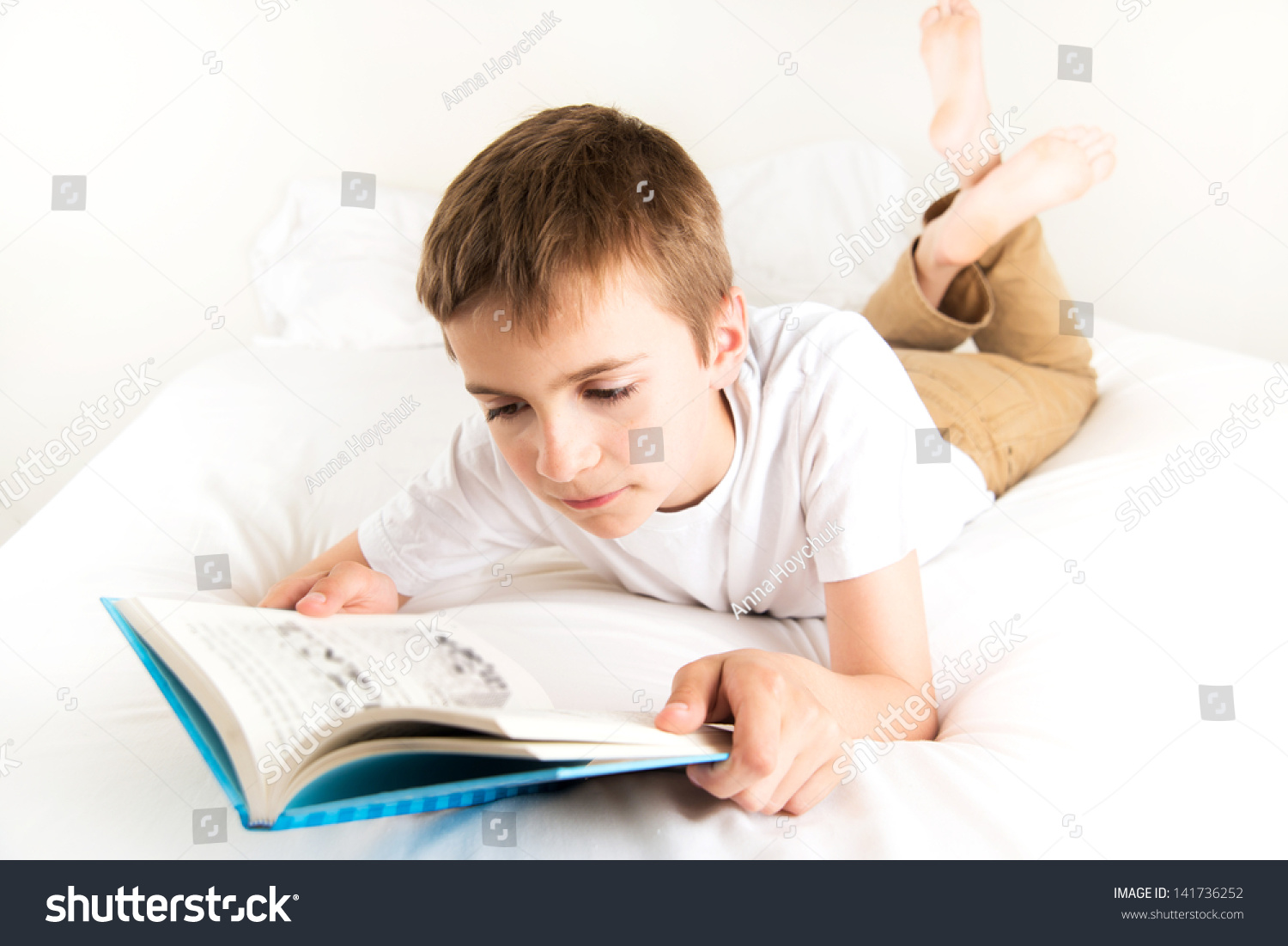 Young Boy Reading Blue Book Bed Stock Photo 141736252 | Shutterstock