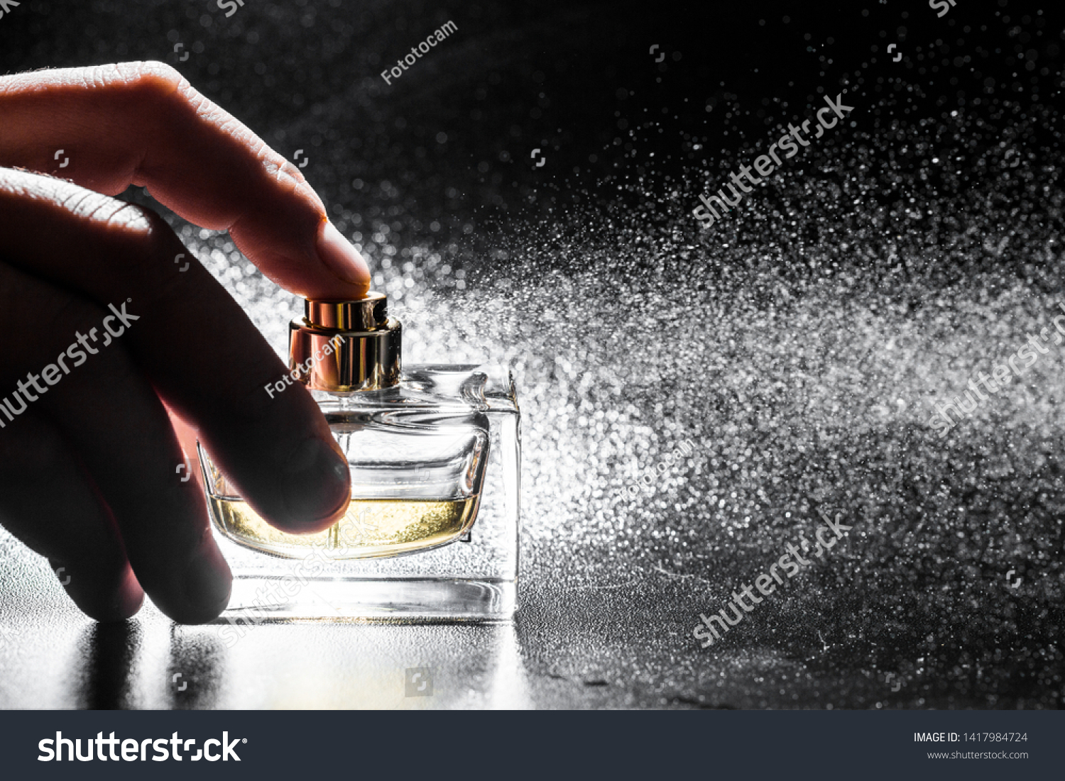 Spraying Perfume On Dark Background Closeup Stock Photo 1417984724 ...