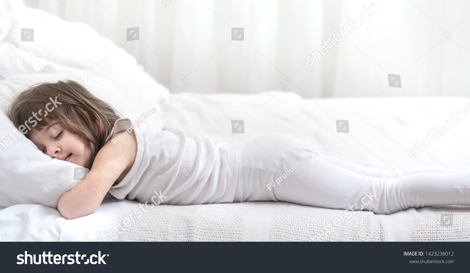 cute-little-girl-smiling-while-lying-stock-photo-1423238012-shutterstock