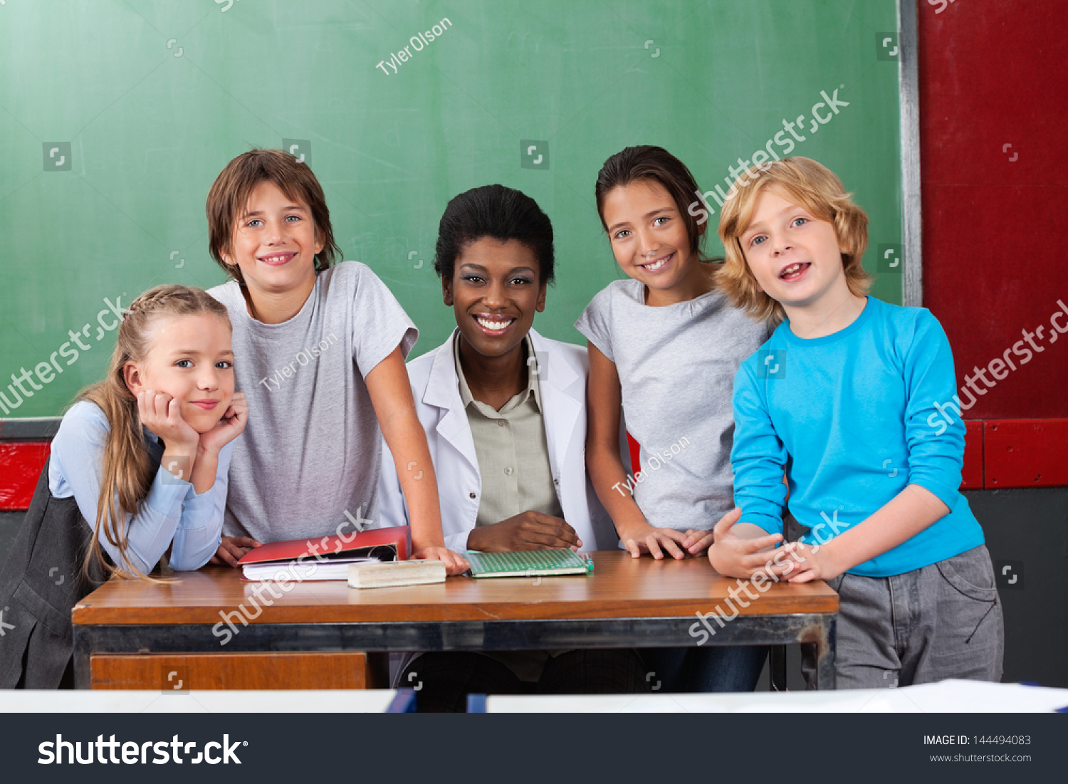 Portrait Female Teacher Students Desk Classroom Stock Photo 144494083 ...