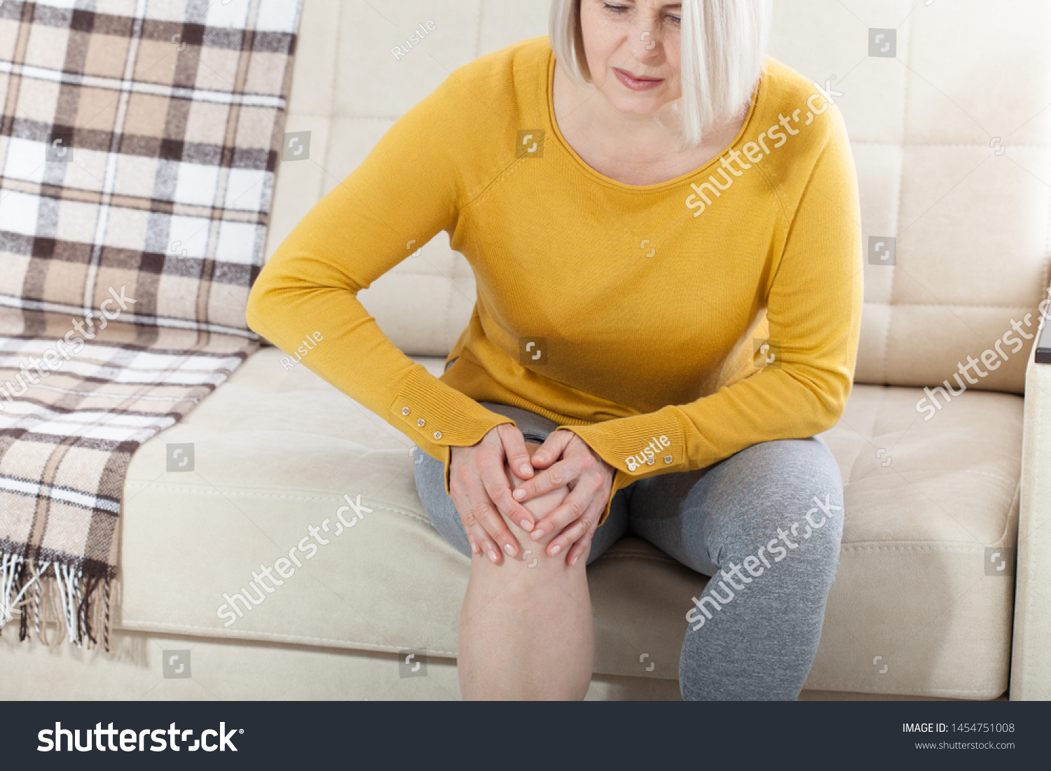 middleaged-woman-suffering-pain-leg-home-stock-photo-1454751008