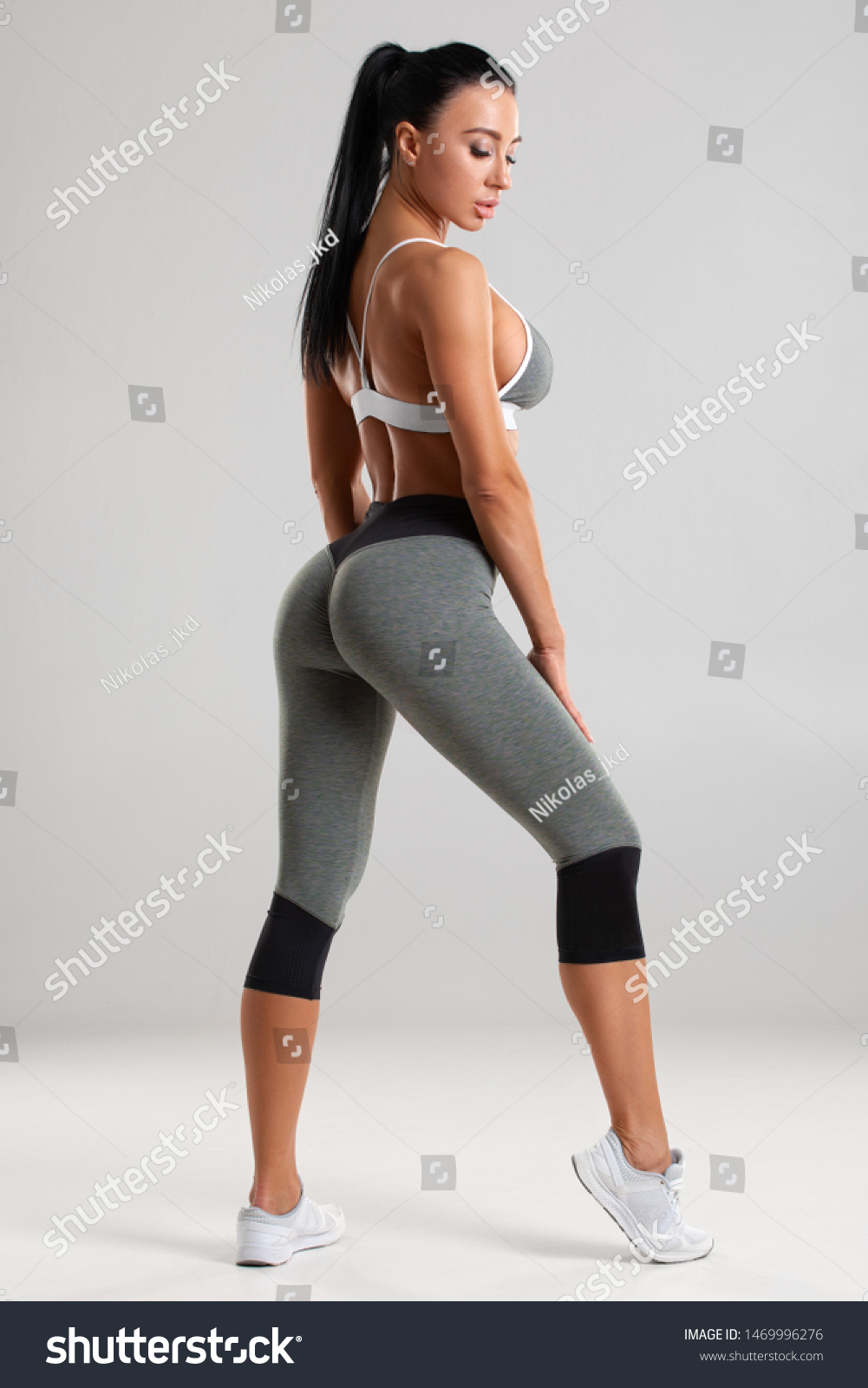 Fitness Woman In Leggings On Gray Background. Athletic Girl With Beautiful  Butt Stock Photo, Picture and Royalty Free Image. Image 137241805.
