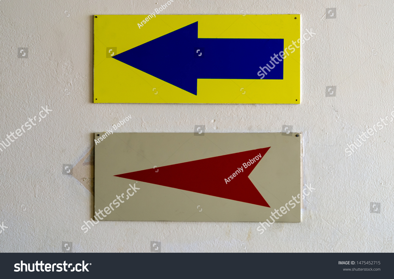 two-signs-on-wall-blue-arrow-stock-photo-1475452715-shutterstock