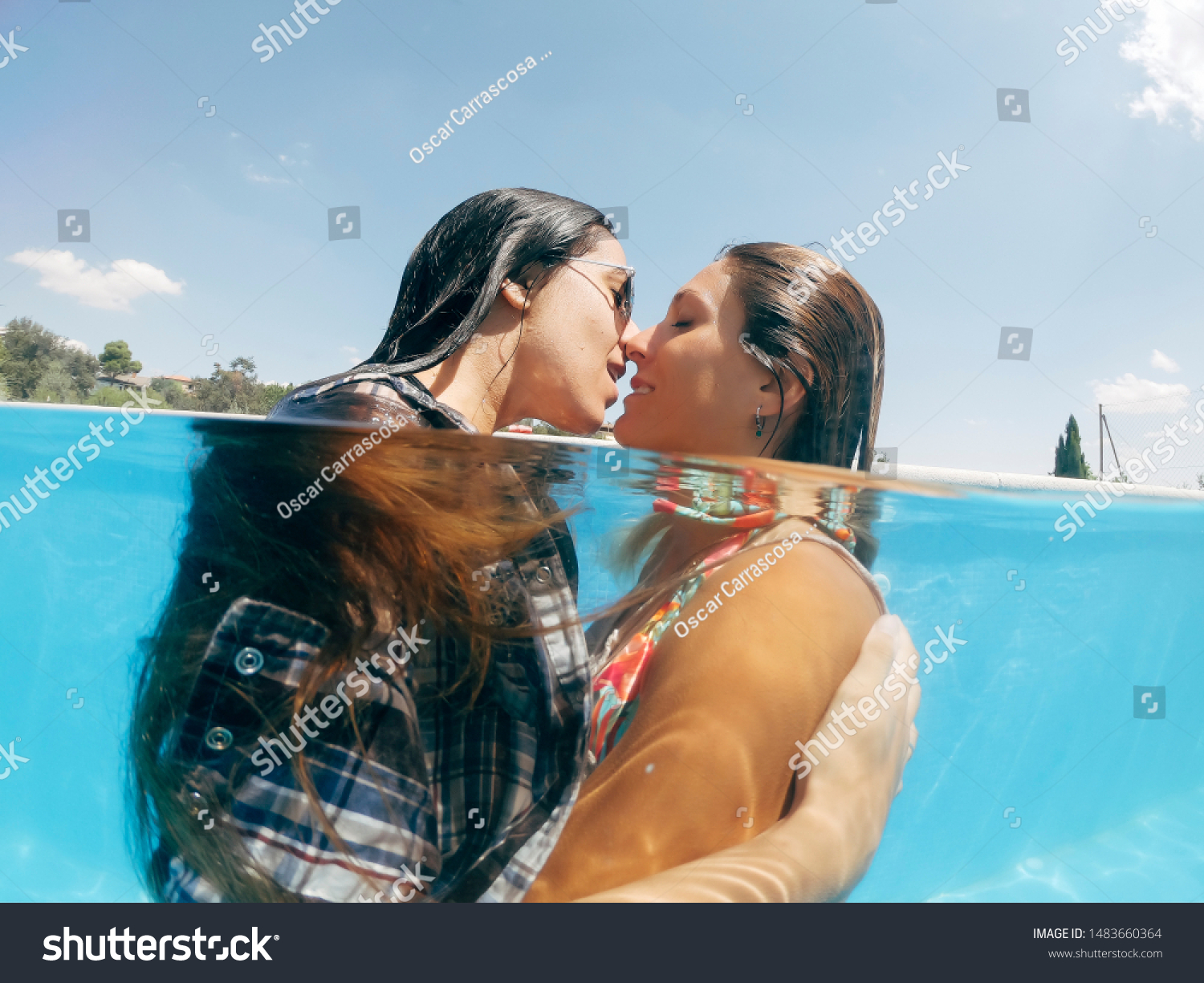 Lesbians topless in swimming pool making out