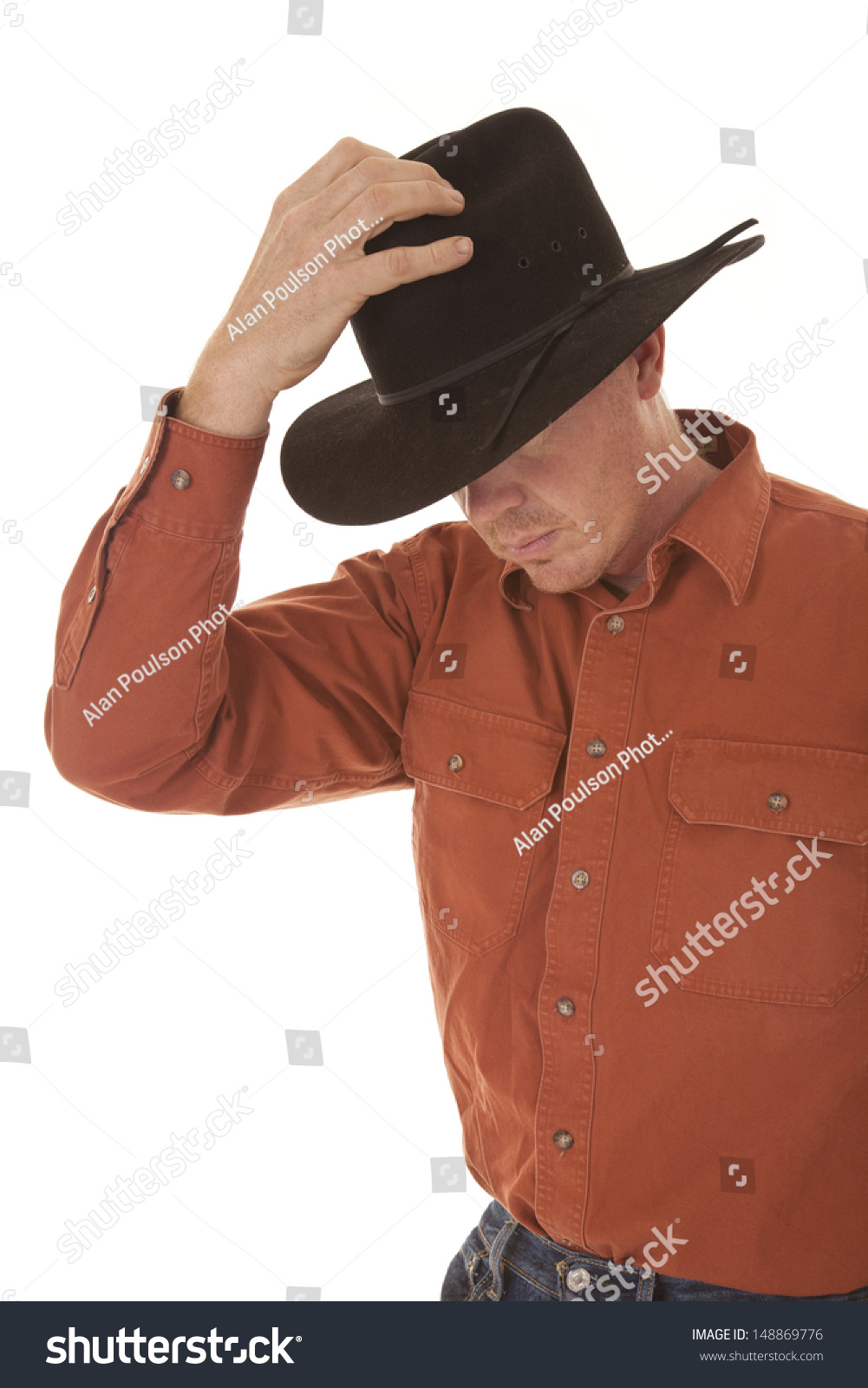 holding cowboy hat