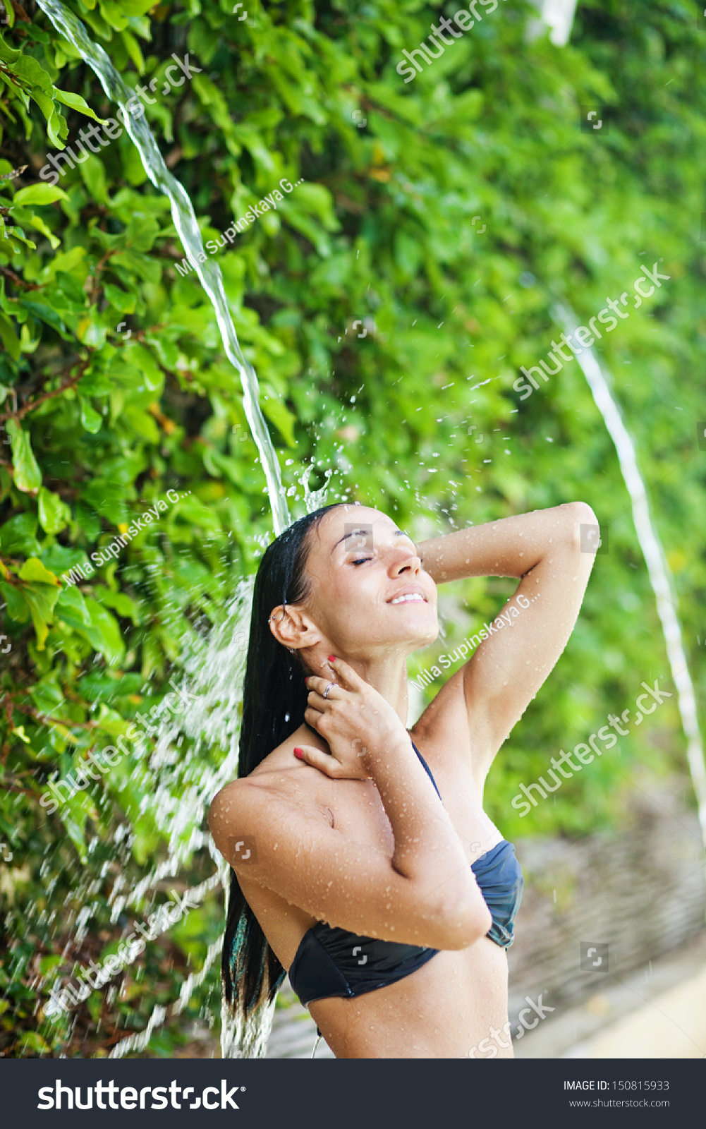 woman-washing-her-hair-under-waterfall-stock-photo-150815933-shutterstock