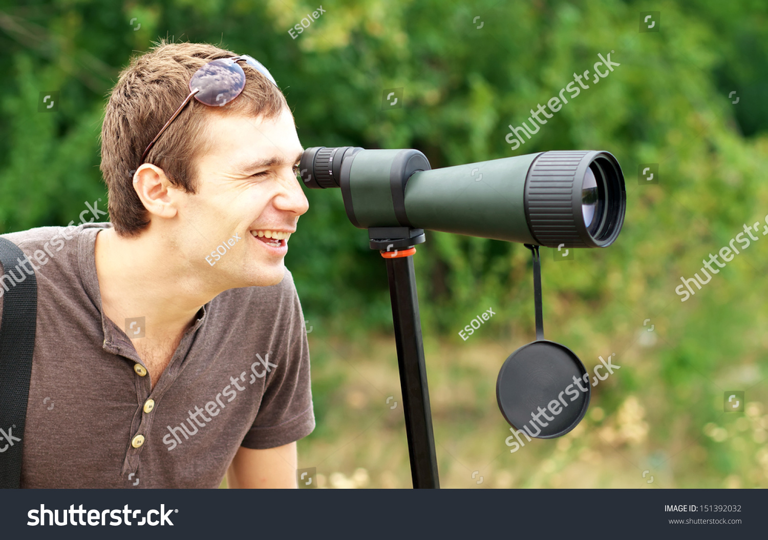 man-who-watching-spotting-scope-positive-stock-photo-151392032