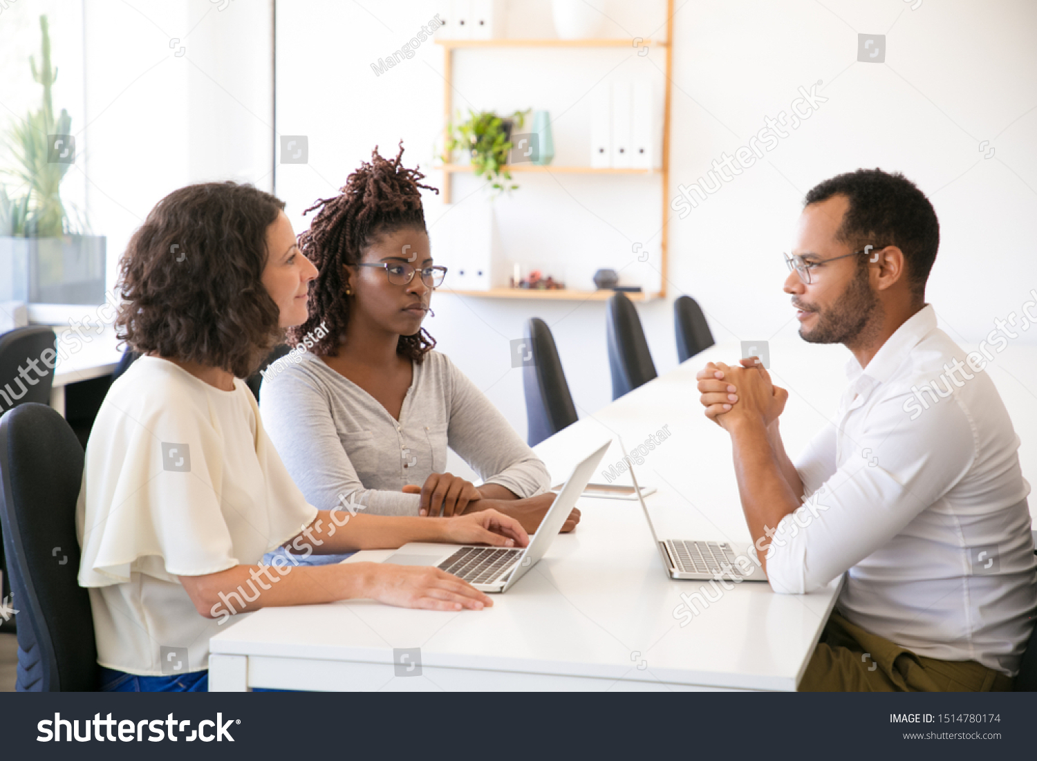 Excited Diverse Business Partners Discussing Programming Stock Photo ...