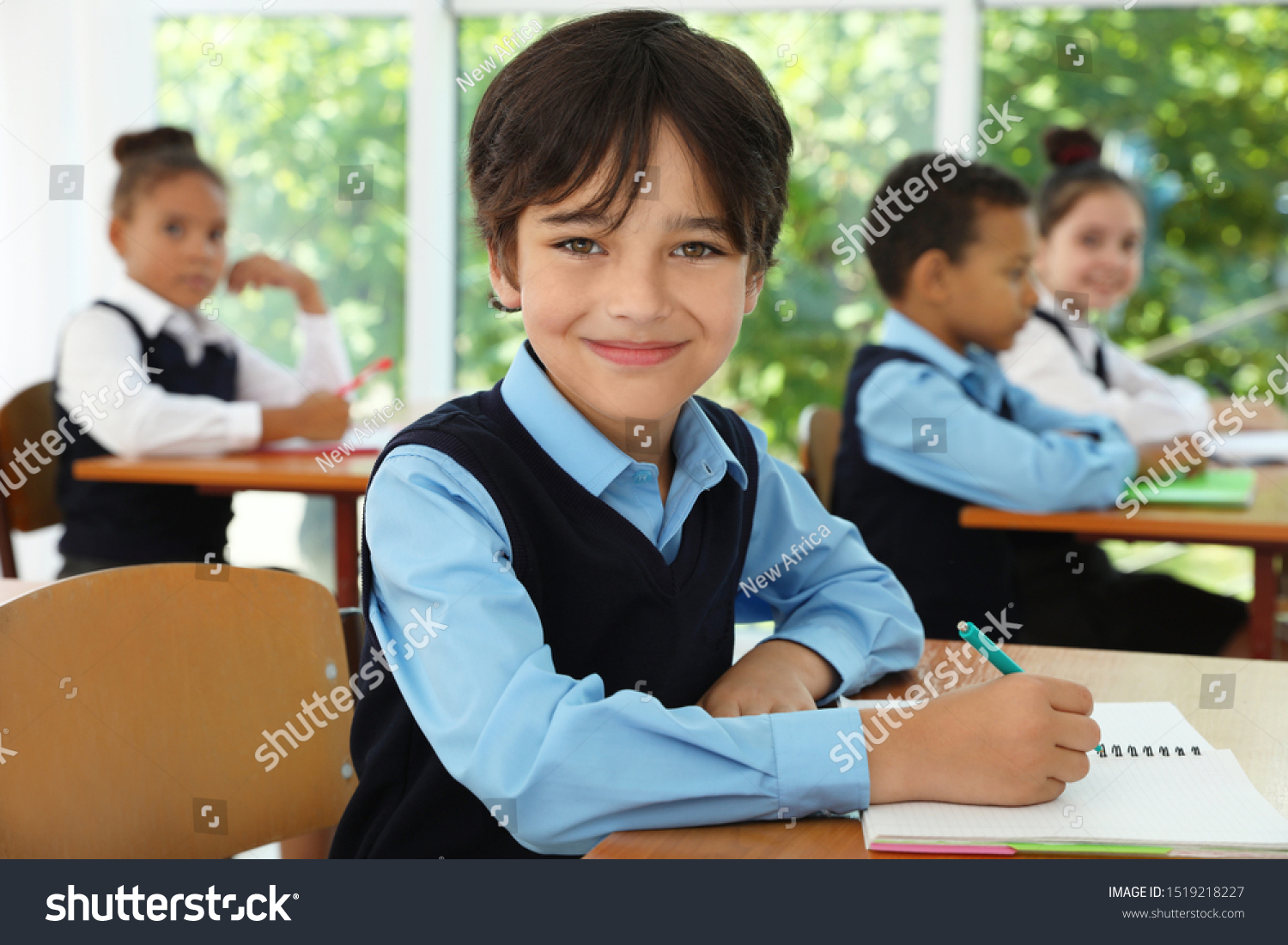 boy-wearing-new-school-uniform-classroom-stock-photo-1519218227