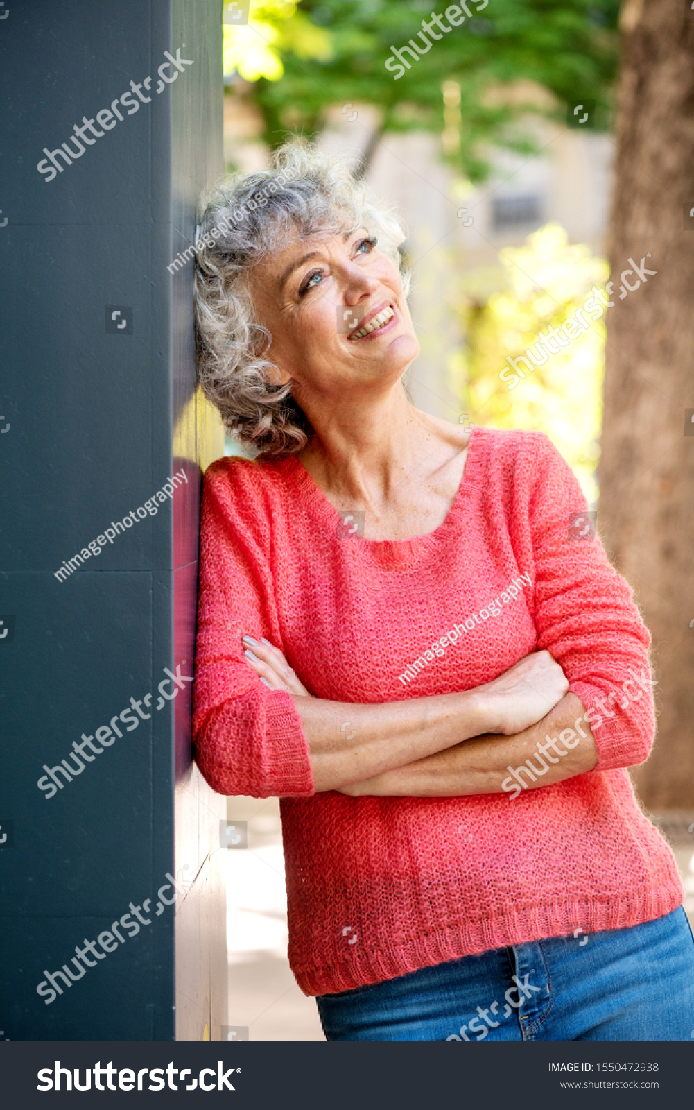 portrait-attractive-older-woman-leaning-against-stock-photo-1550472938