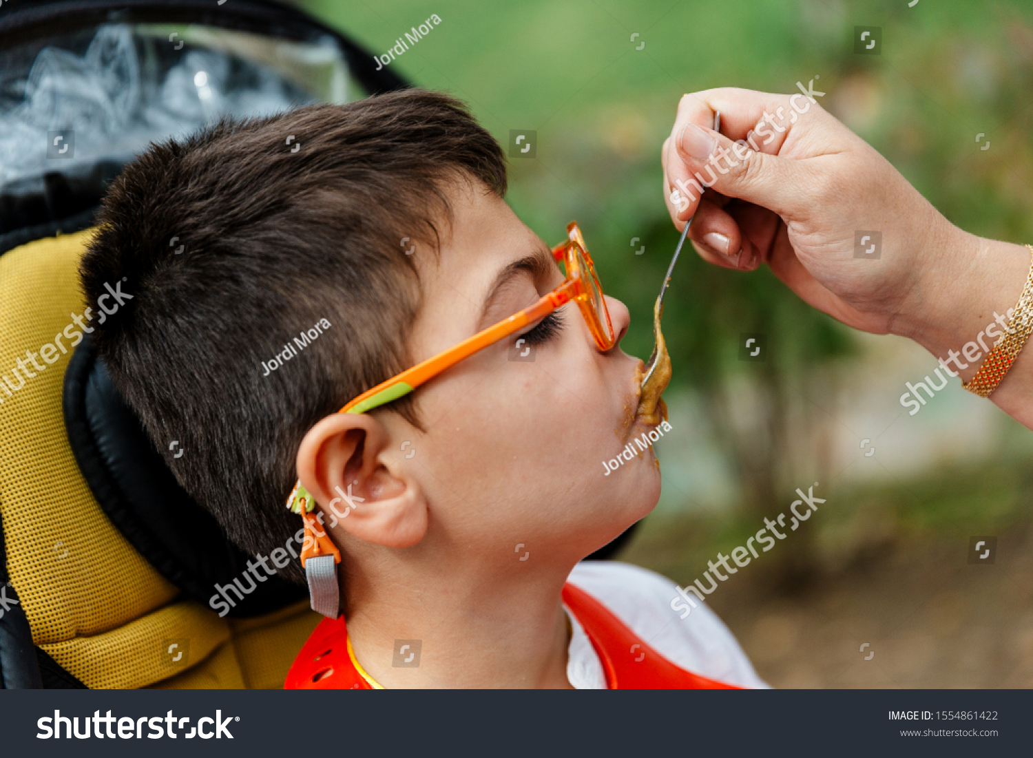 Small Child Mobility Impairment Quadriplegic Eating Stock Photo