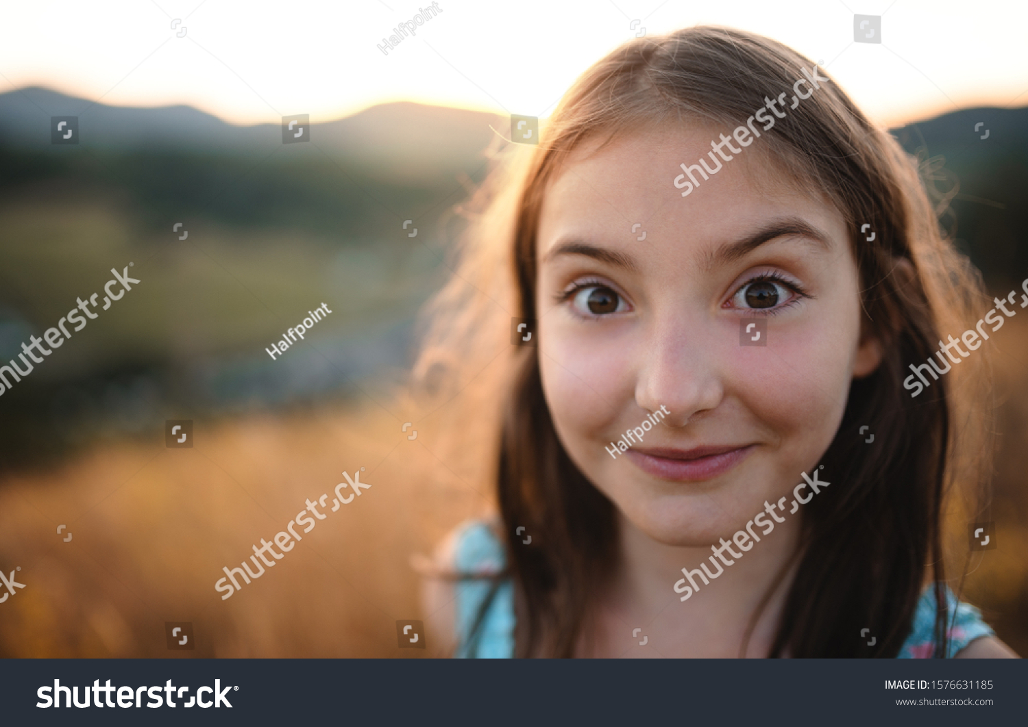 portrait-small-girl-nature-looking-camera-stock-photo-1576631185