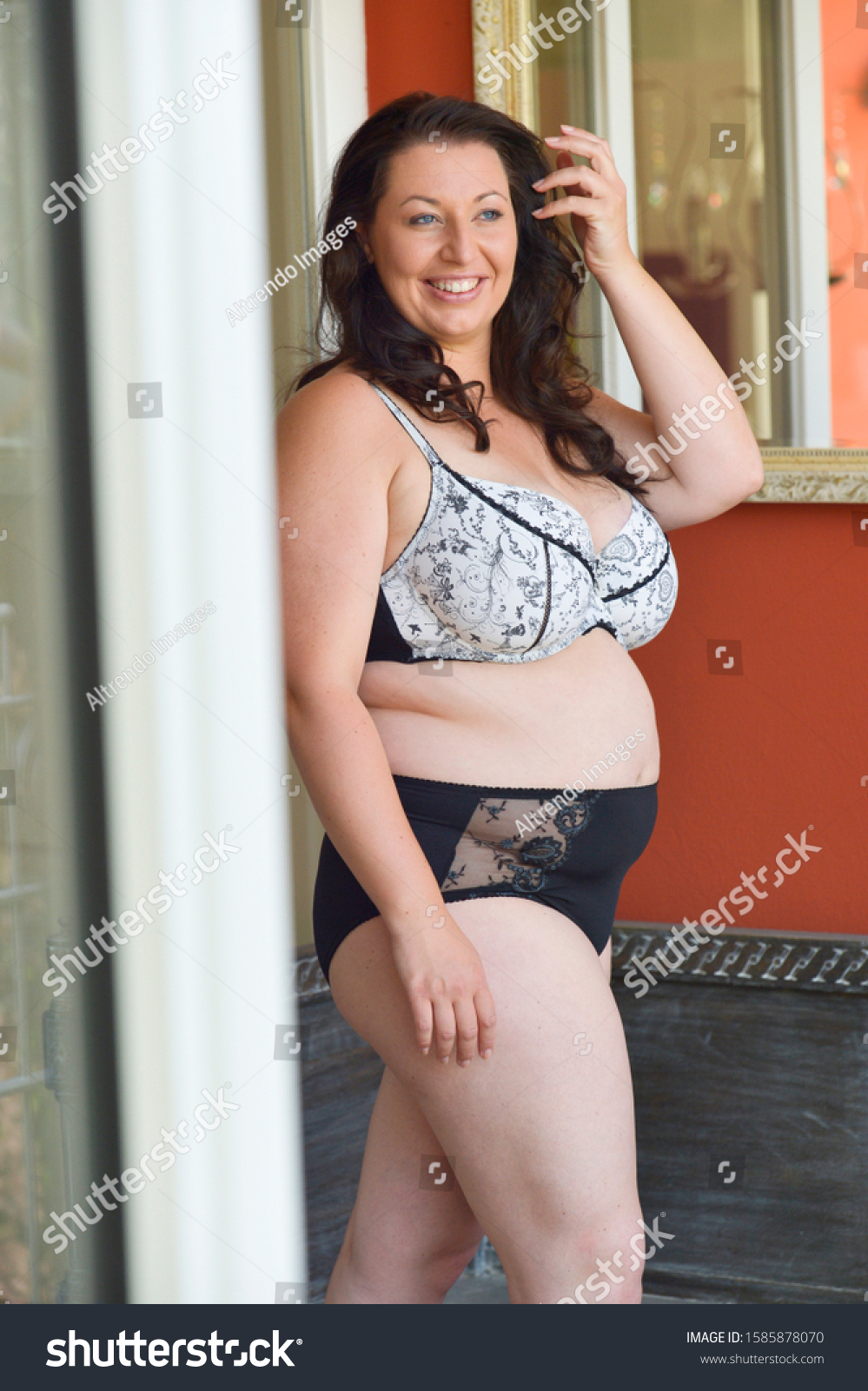 stock-photo-mid-adult-woman-in-lingerie-smiling-1585878070.jpg