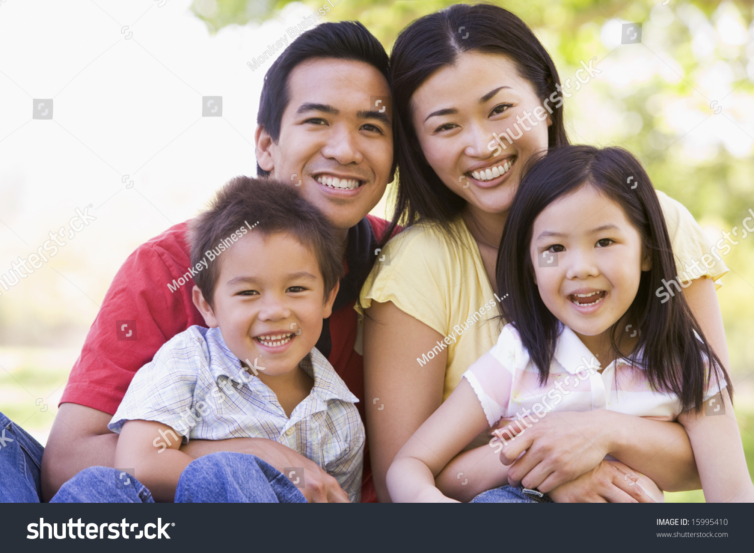 Family Sitting Outdoors Smiling Stock Photo 15995410 | Shutterstock