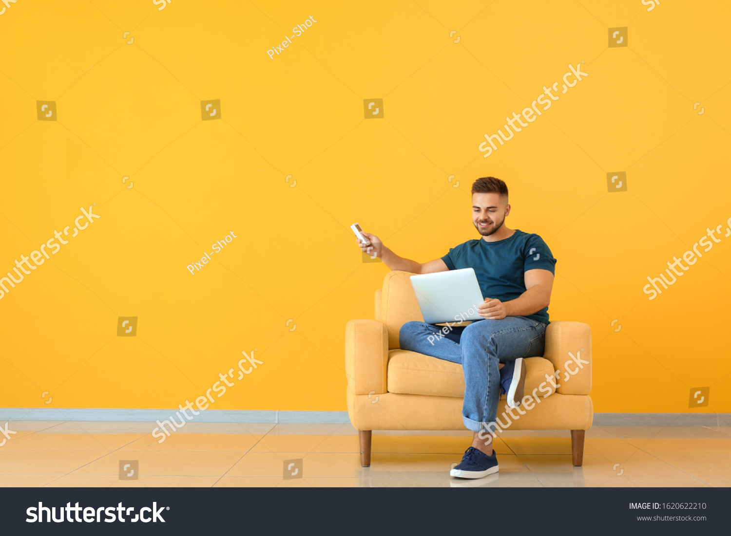 young-man-switching-on-air-conditioner-stock-photo-1620622210