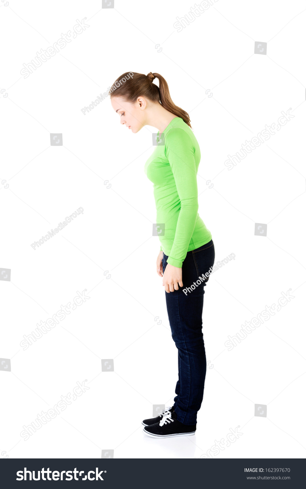 Attractive Young Woman Standing Looking Down Stock Photo 162397670 ...