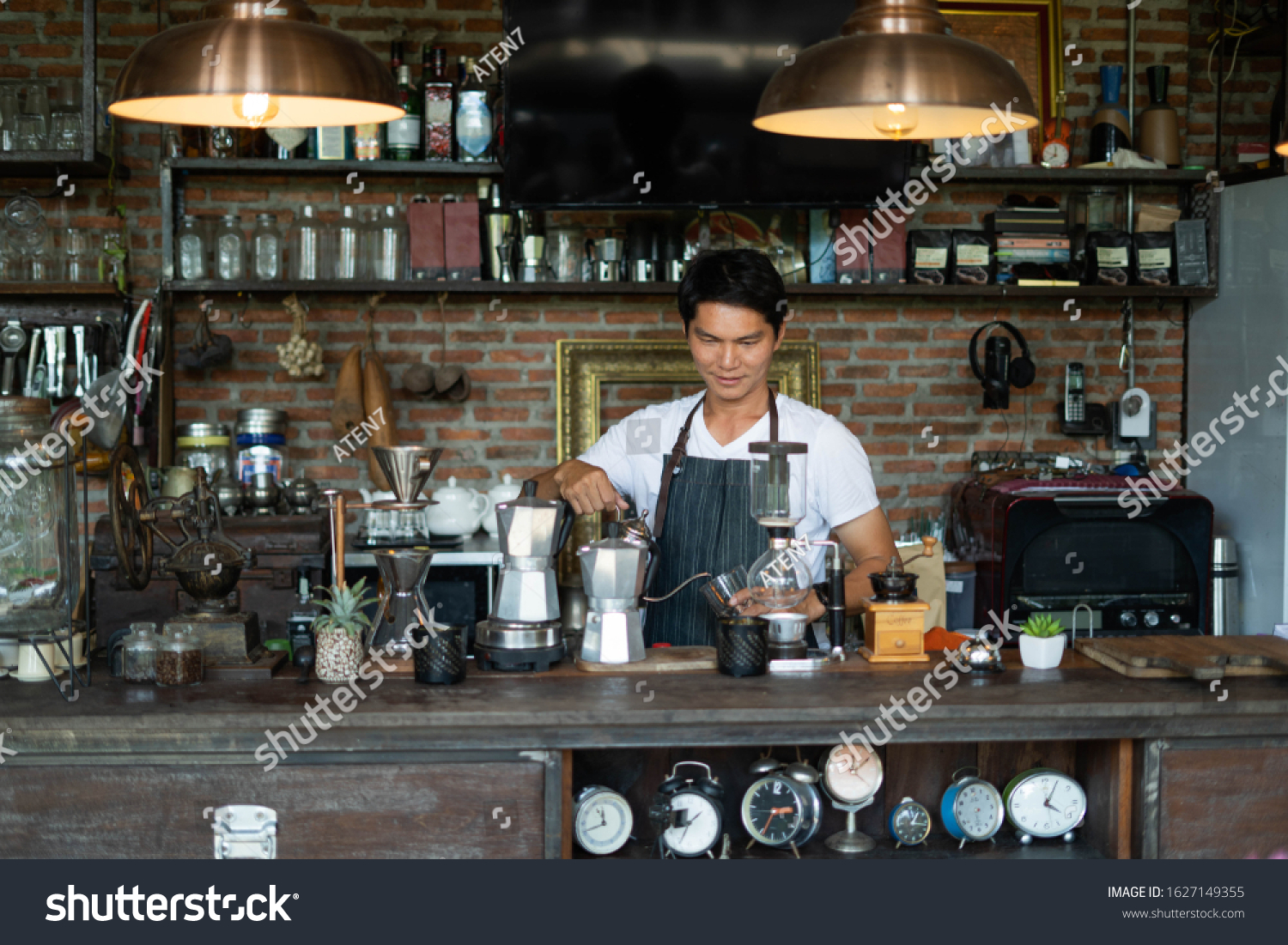 elderly-asian-woman-who-owns-a-coffee-shop-taking-customer-orders-over