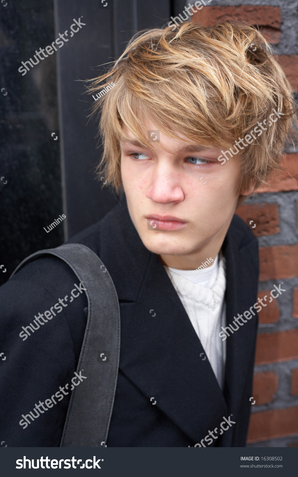 teenage-boy-looking-over-shoulder-outside-stock-photo-16308502